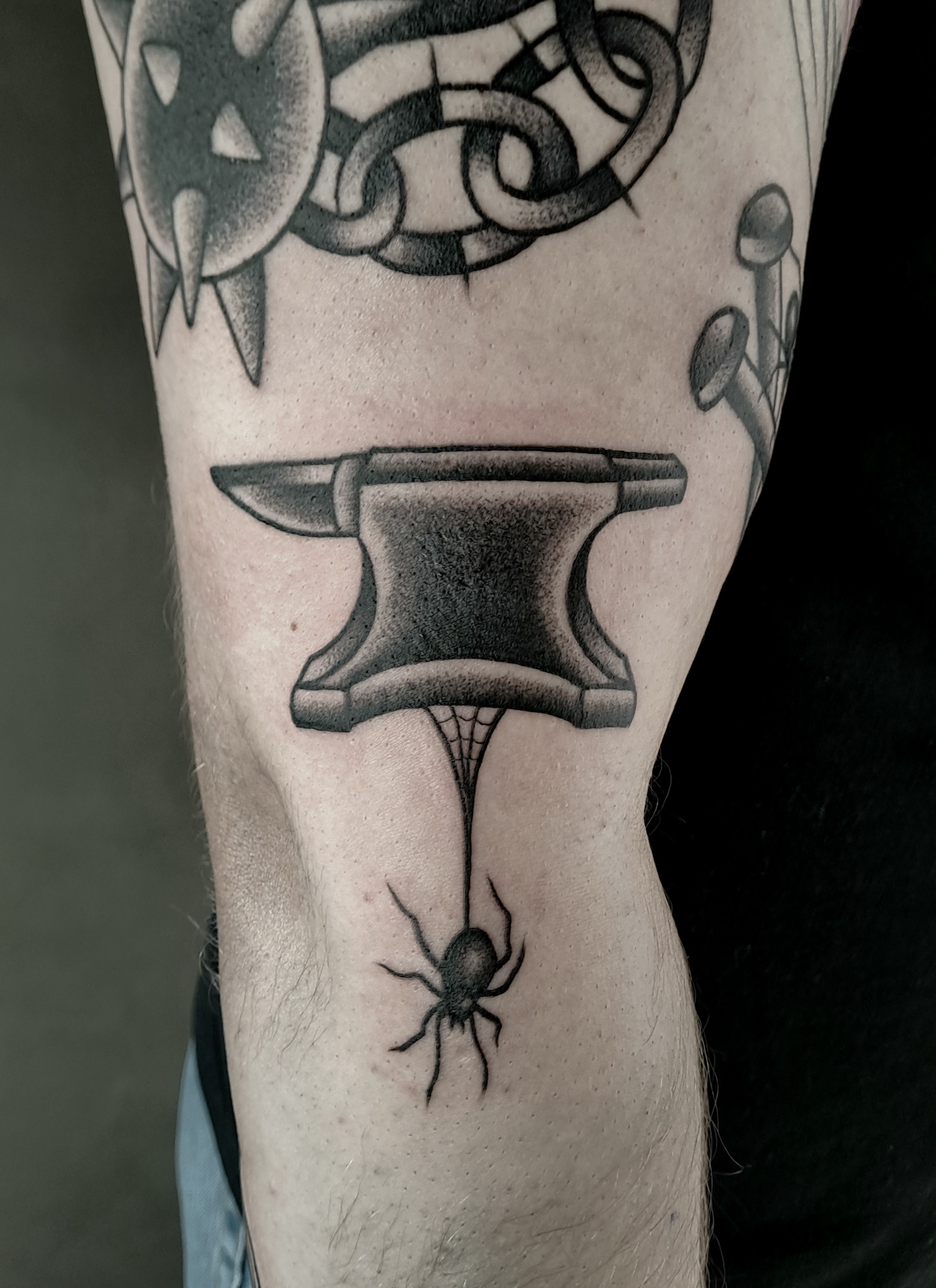 Traditional blackwork anvil and spider tattoo
