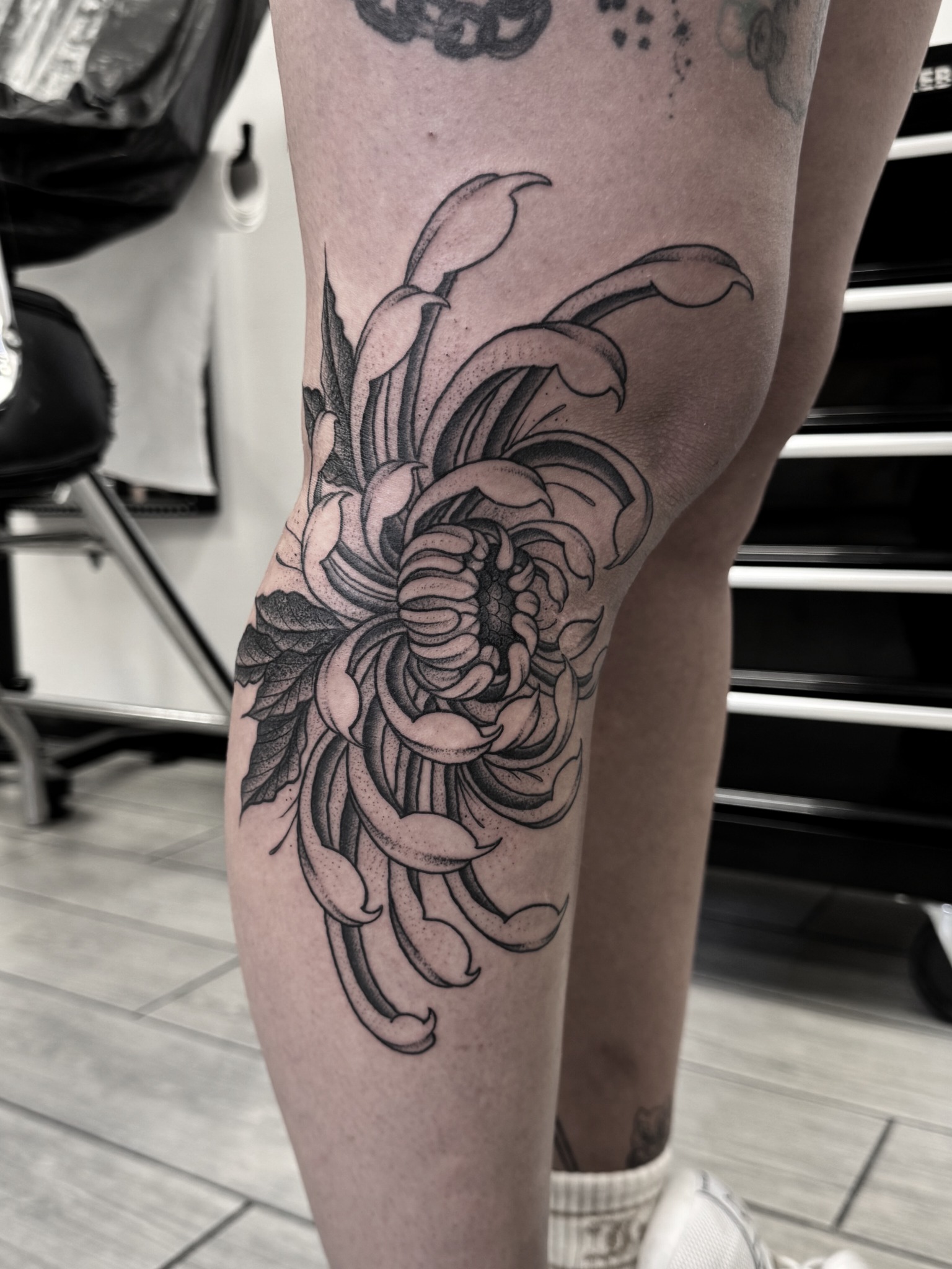 Blackwork chrysanthemum tattoo