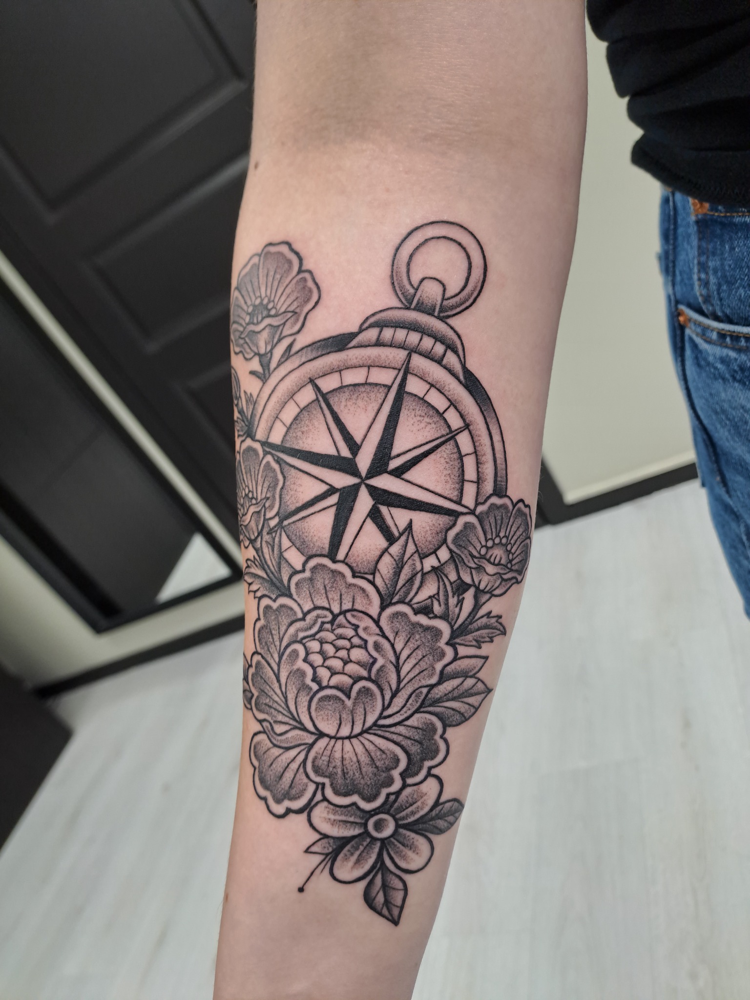 Blackwork compass and flowers tattoo