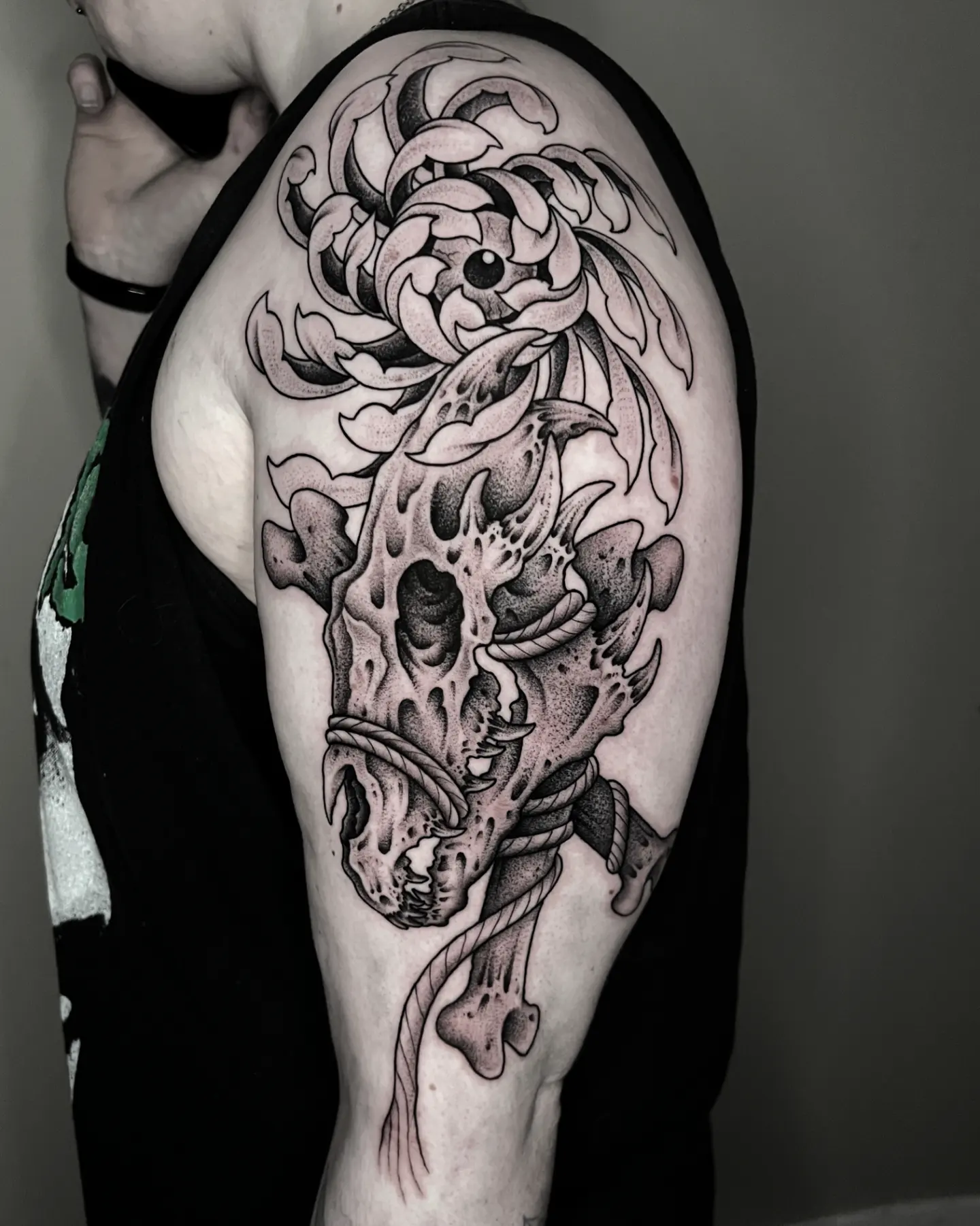 Illustrative blackwork dragon skull tattoo