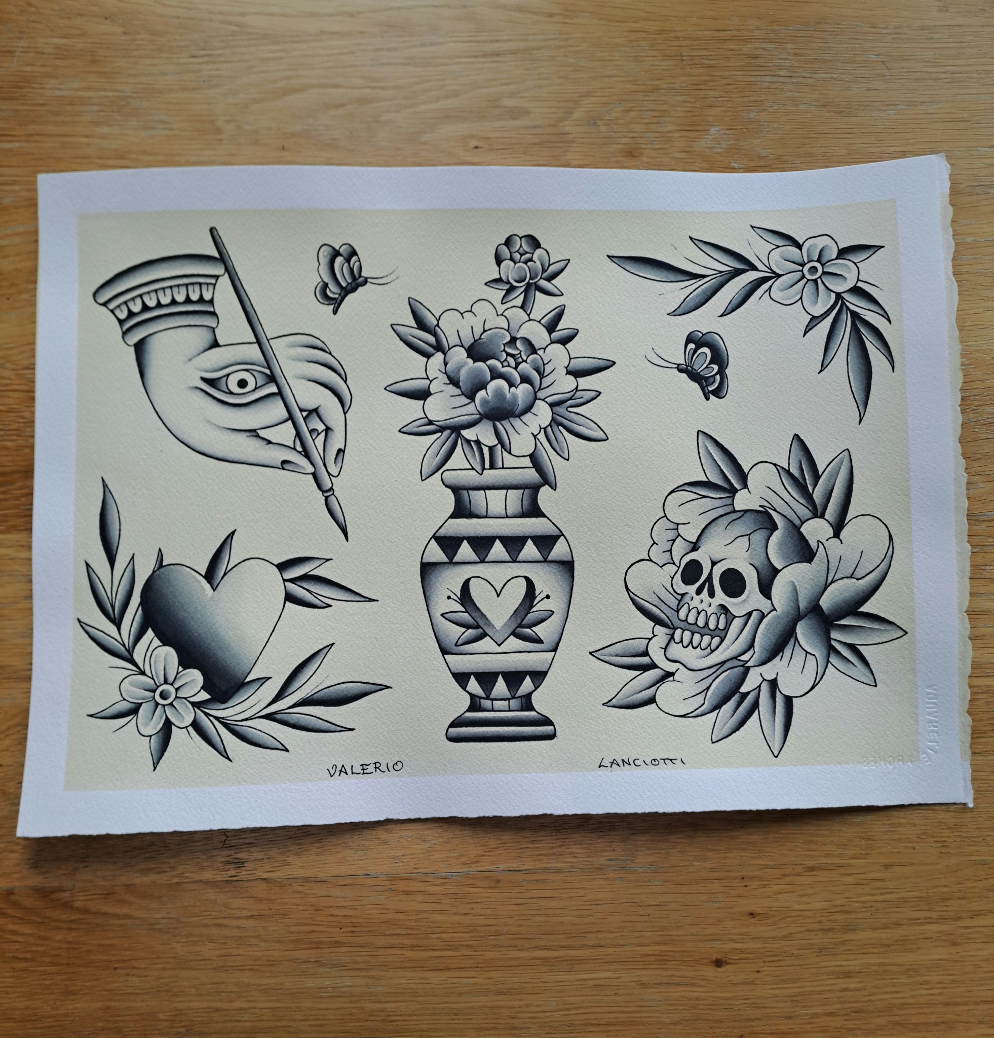Tattoo flash sheet with flowers, vase, skull and hand