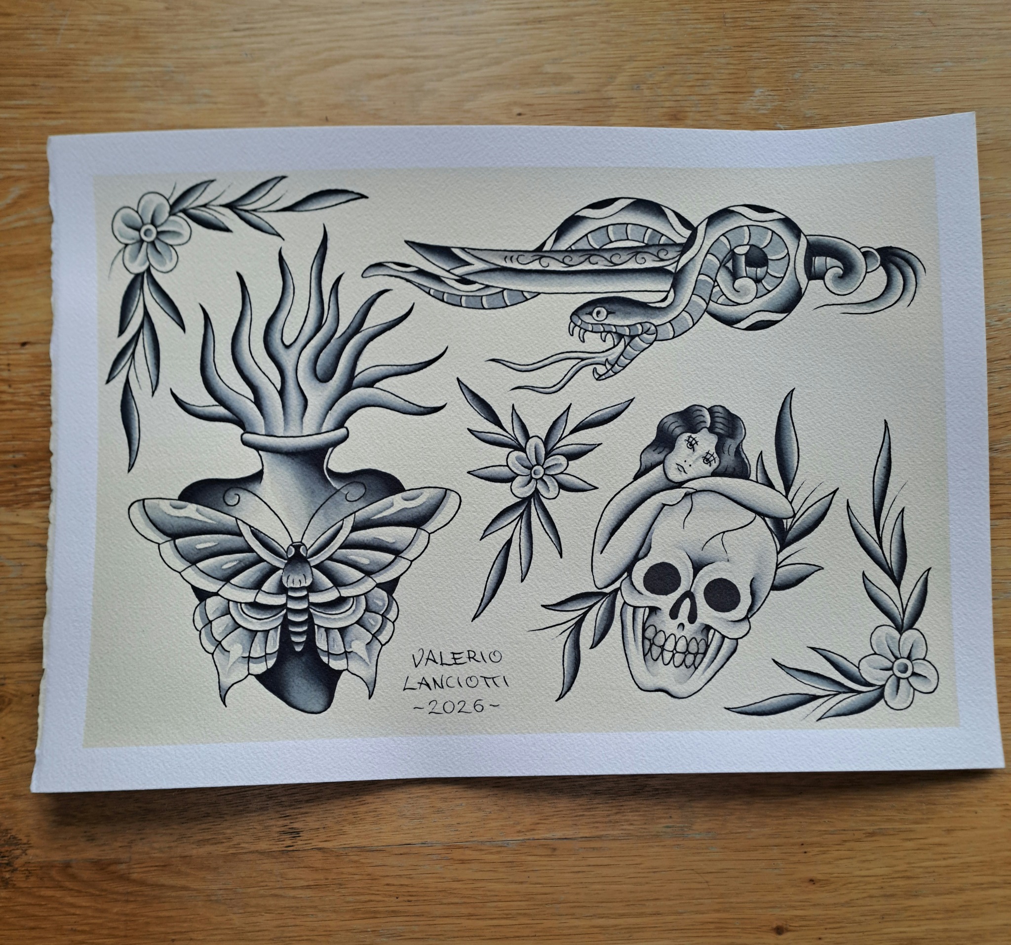 Tattoo flash sheet with moth, snake, skull and flowers