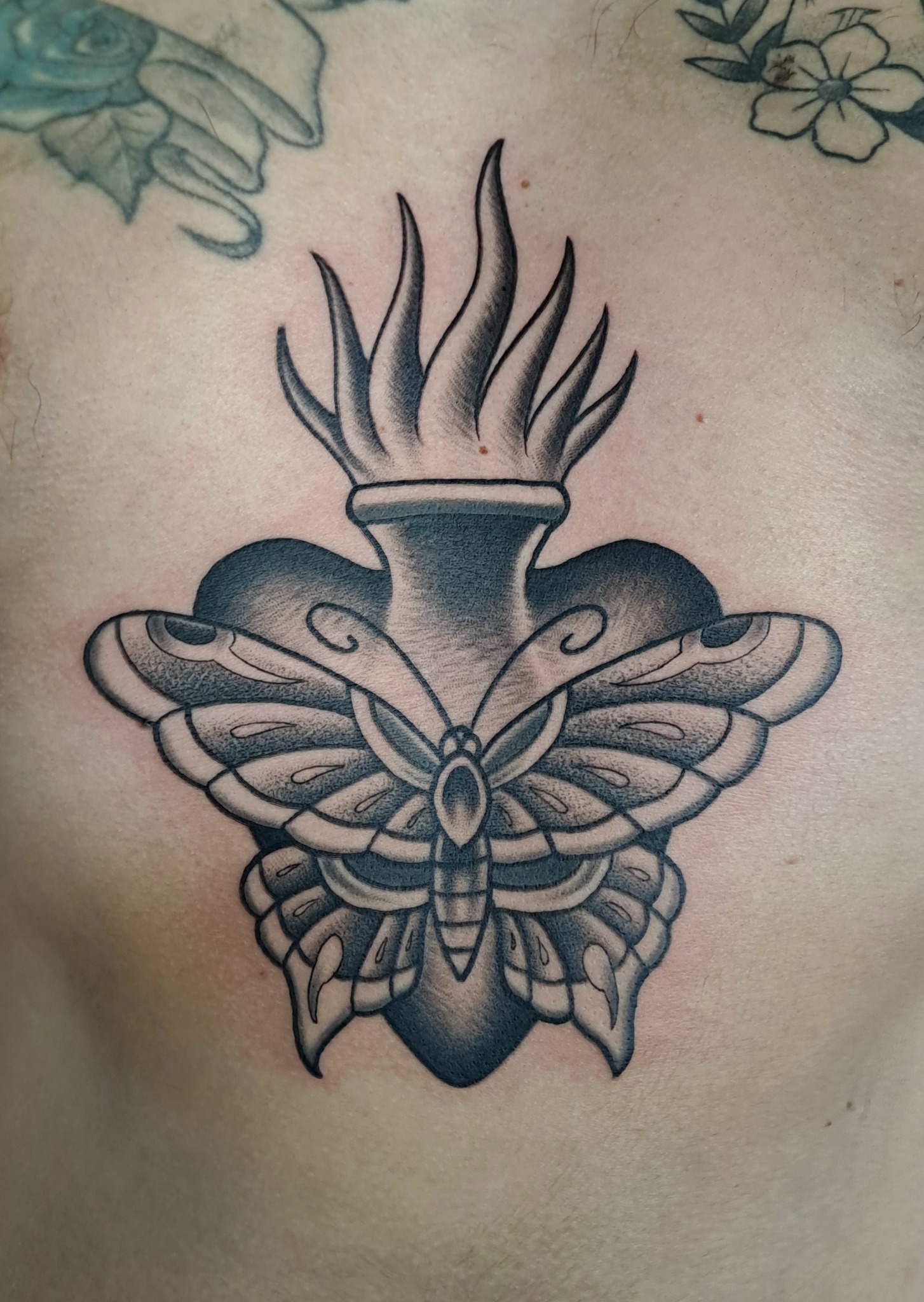 Traditional blackwork moth tattoo