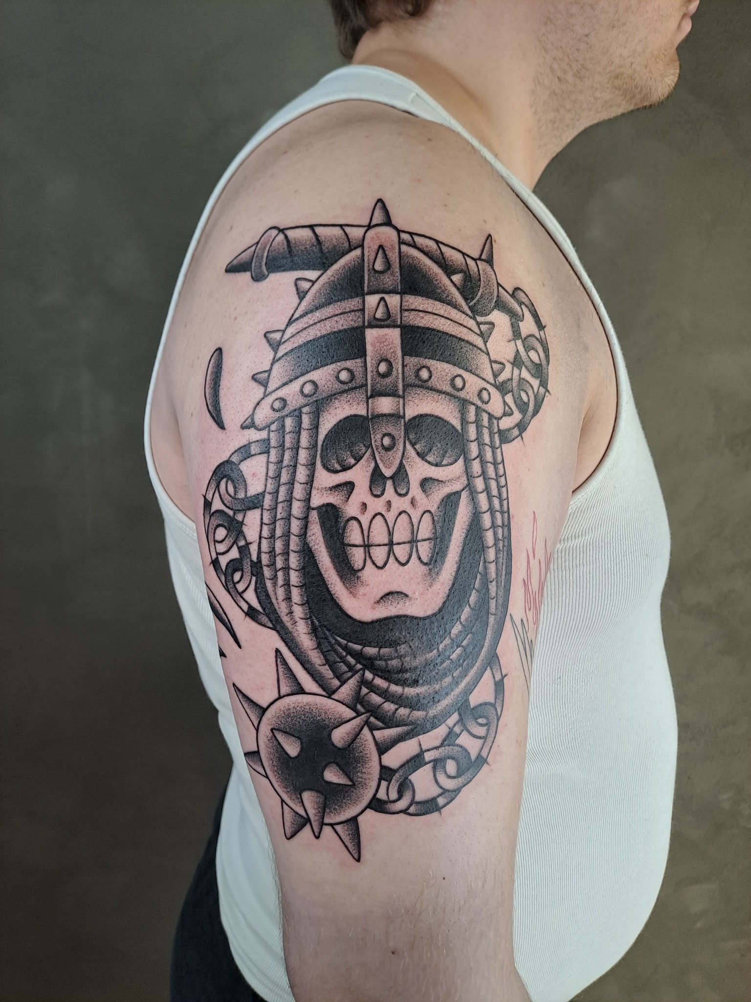 Illustrative skull and helmet tattoo